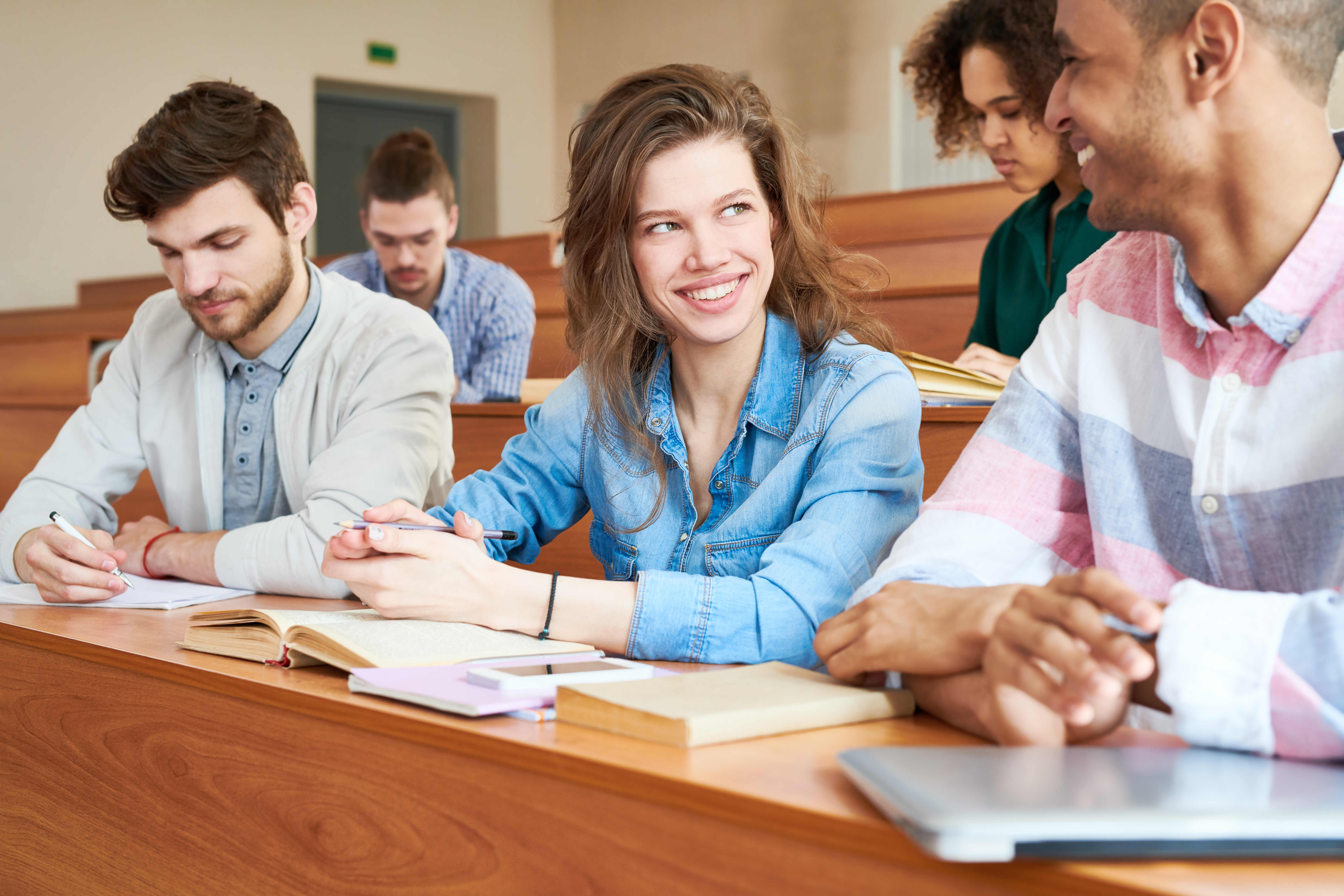 how long does cert iv in training and assessment take - Pretty student girl talking to groupmate at class