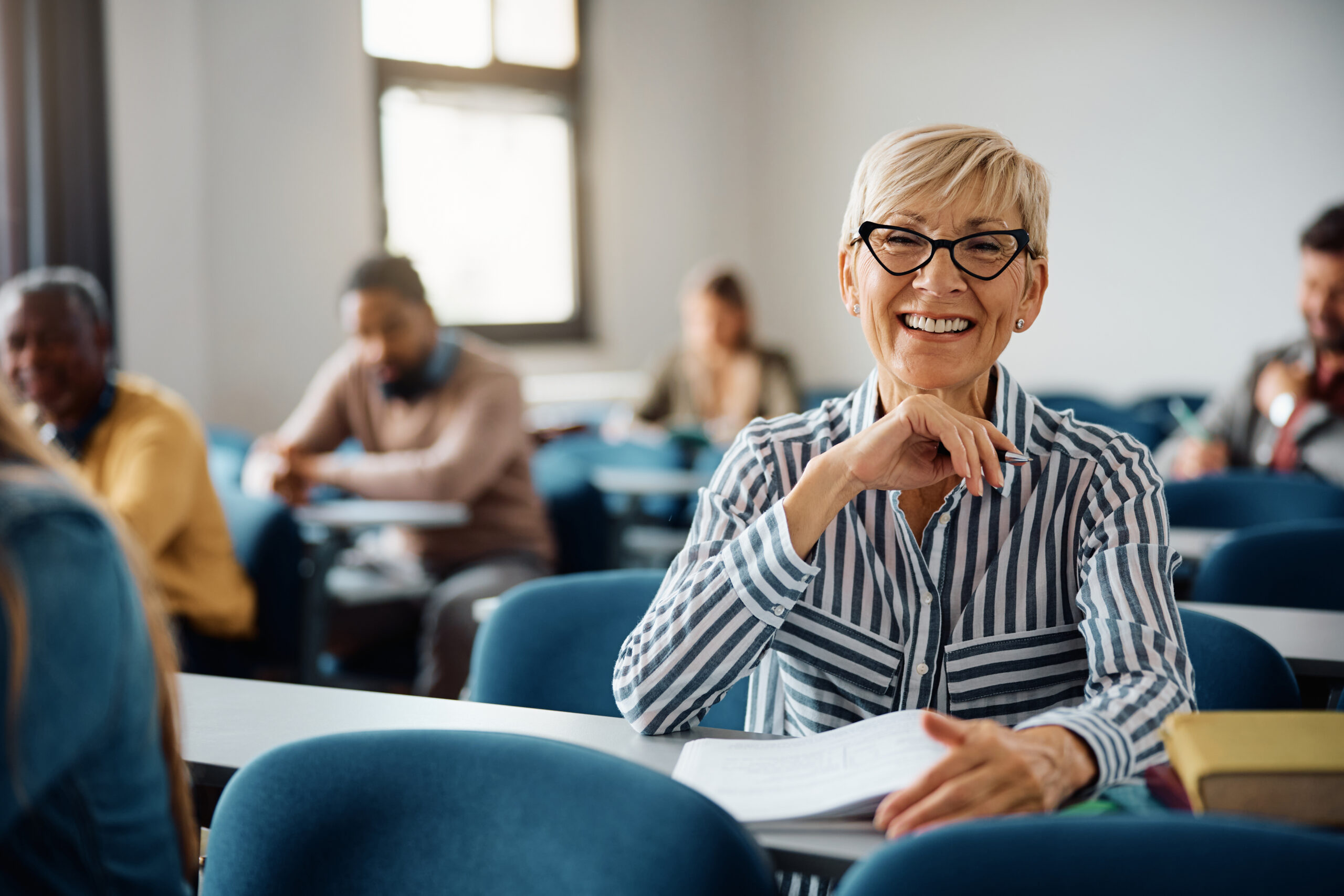 certificate iv in training and assessment brisbane - Happy mature woman attending adult education training course and looking at camera.